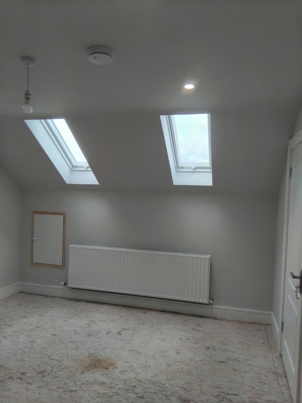 Finished attic conversion with skylights by A Cut Above Carpentry